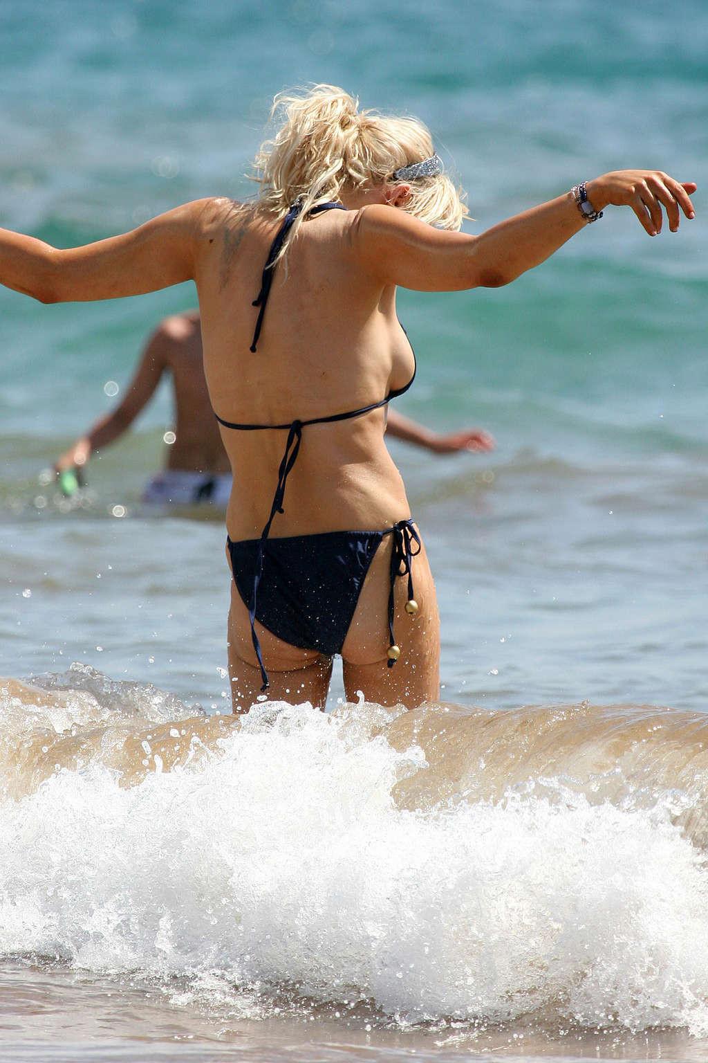 16P Courtney Love posing on the beach in black bikini and showing sexy body