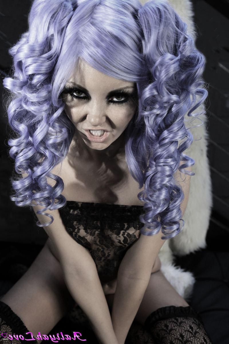 16P Aaliyah Love poses in a purple wig and sheer stockings