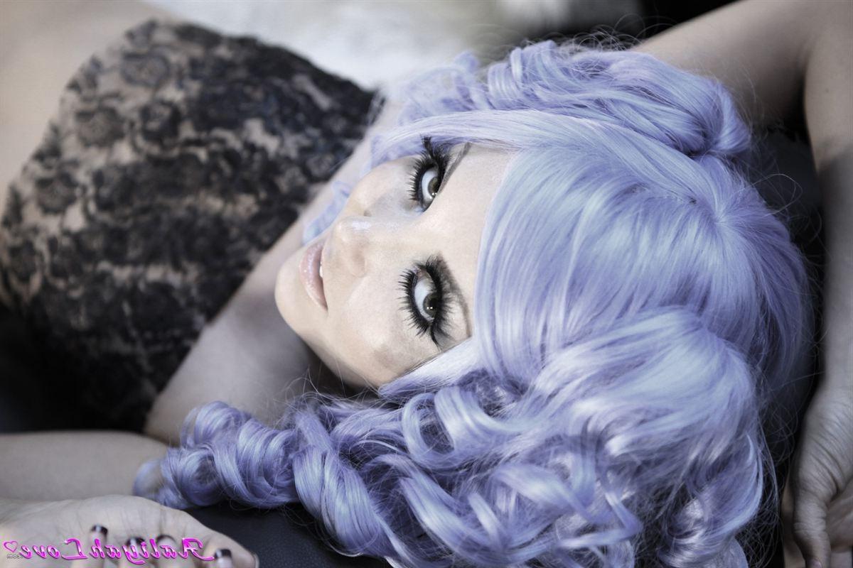 16P Aaliyah Love poses in a purple wig and sheer stockings