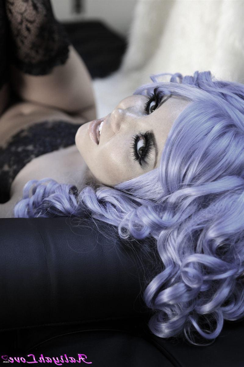 16P Aaliyah Love poses in a purple wig and sheer stockings