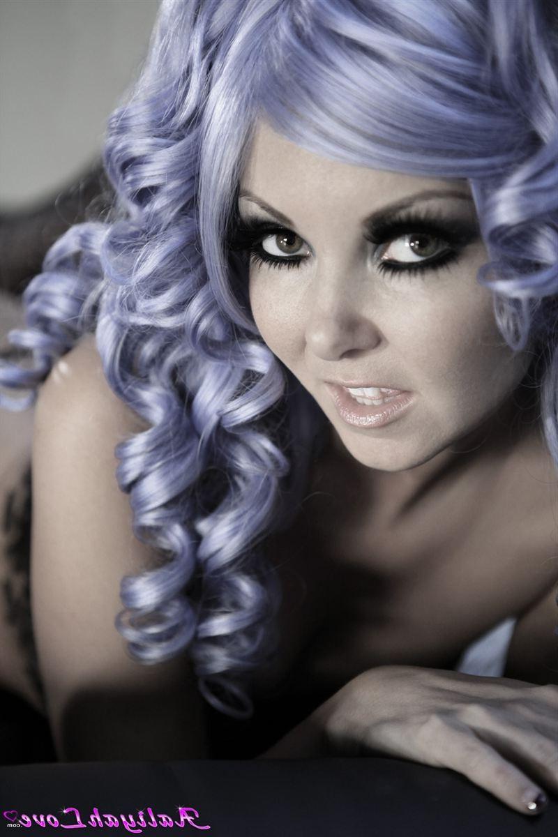 16P Aaliyah Love poses in a purple wig and sheer stockings