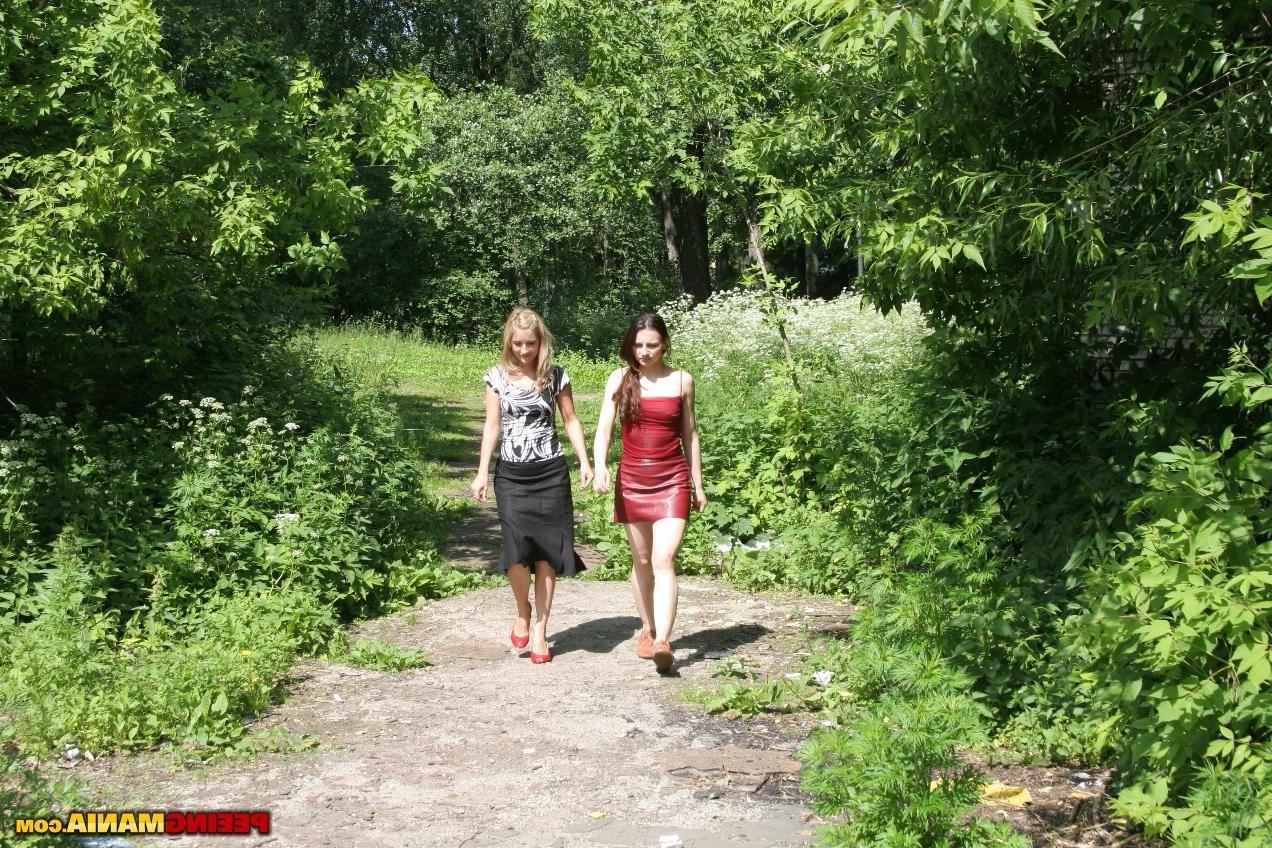 11P A brune gal in red and a blondie in black wet their panties outdoors