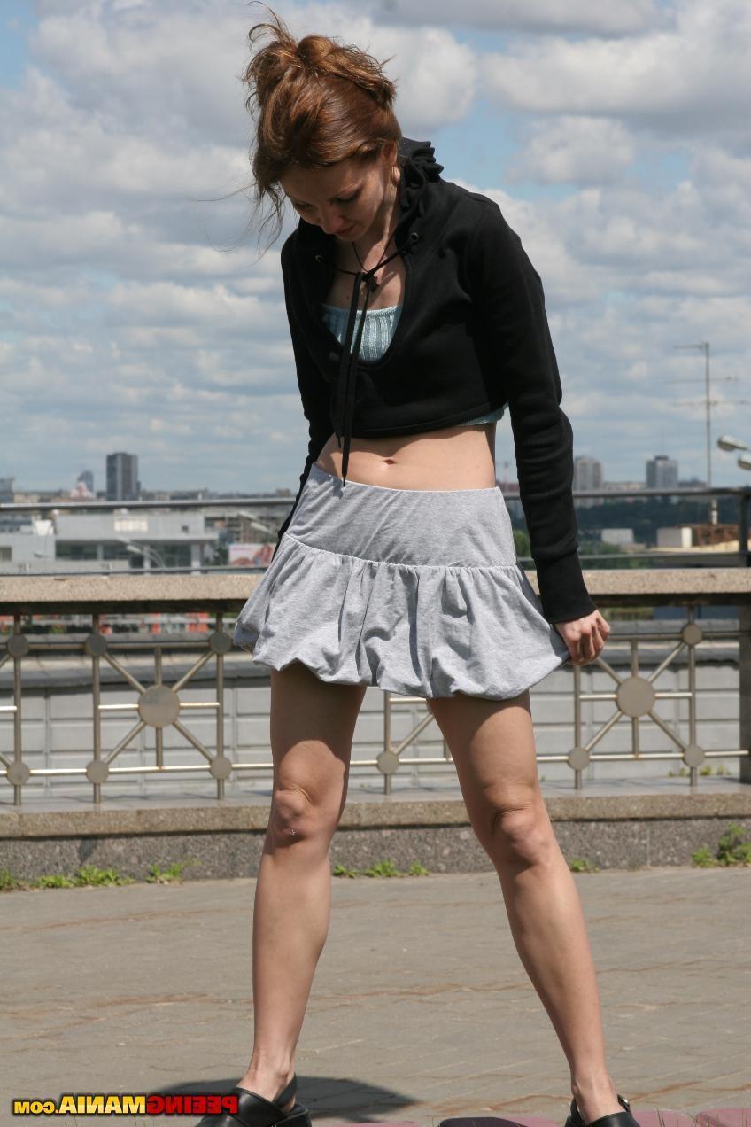 15P Miss in a pleated skirt pees thru the aquamarine panties in the street