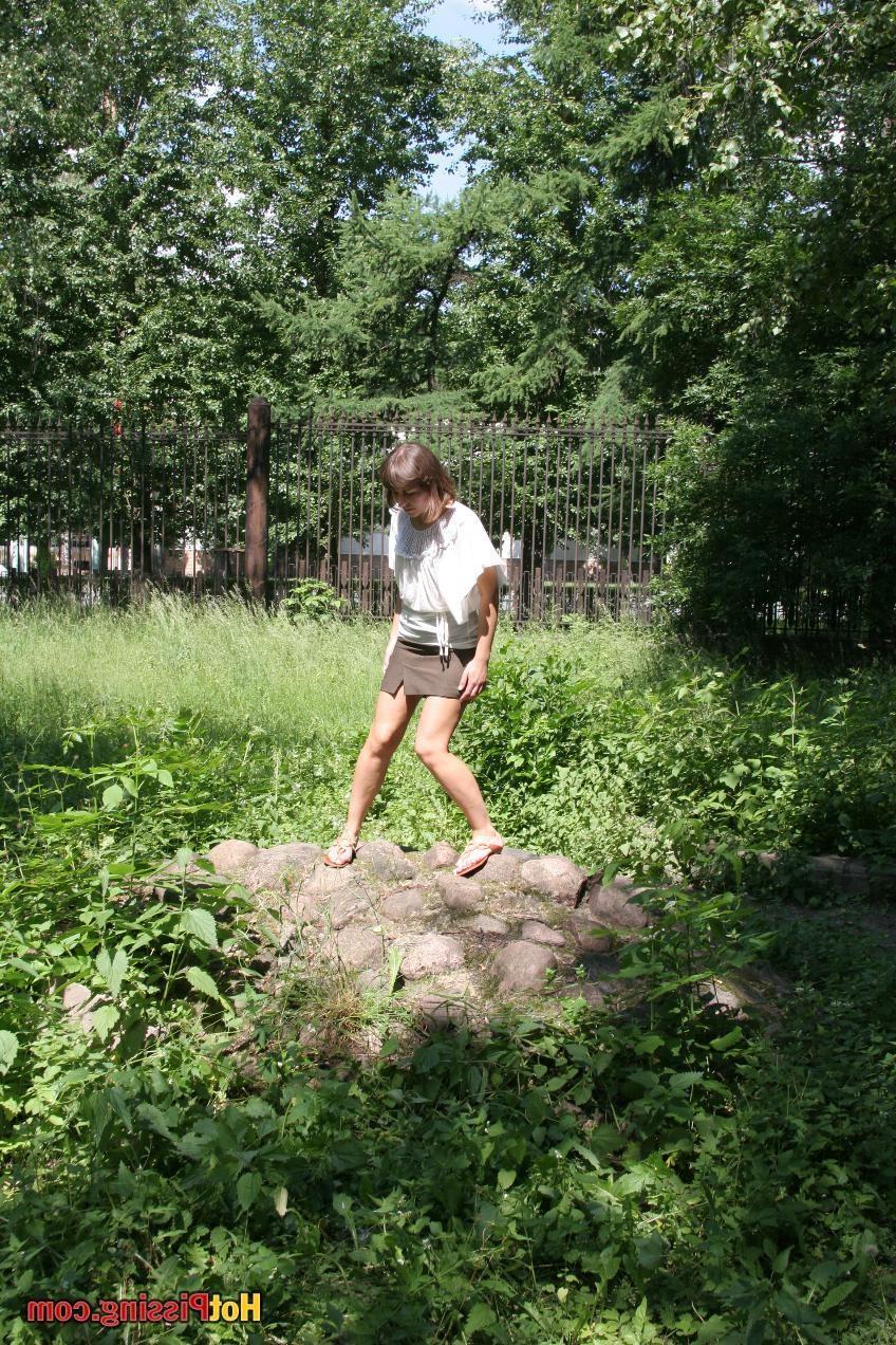 15P Pretty girl in a brown mini skirt with a cut splashes on the stones