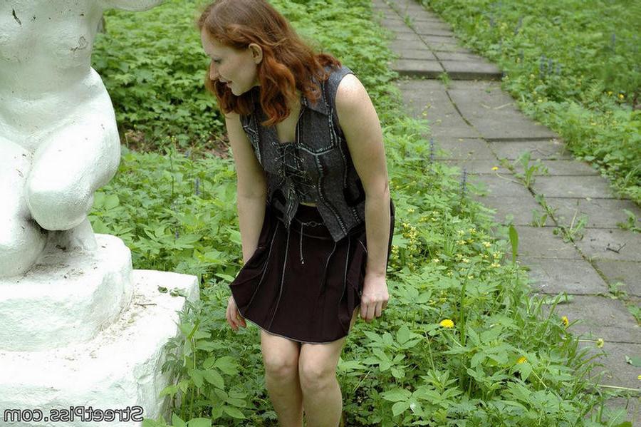 12P Shy redhead spreads legs to wet a park sculpture