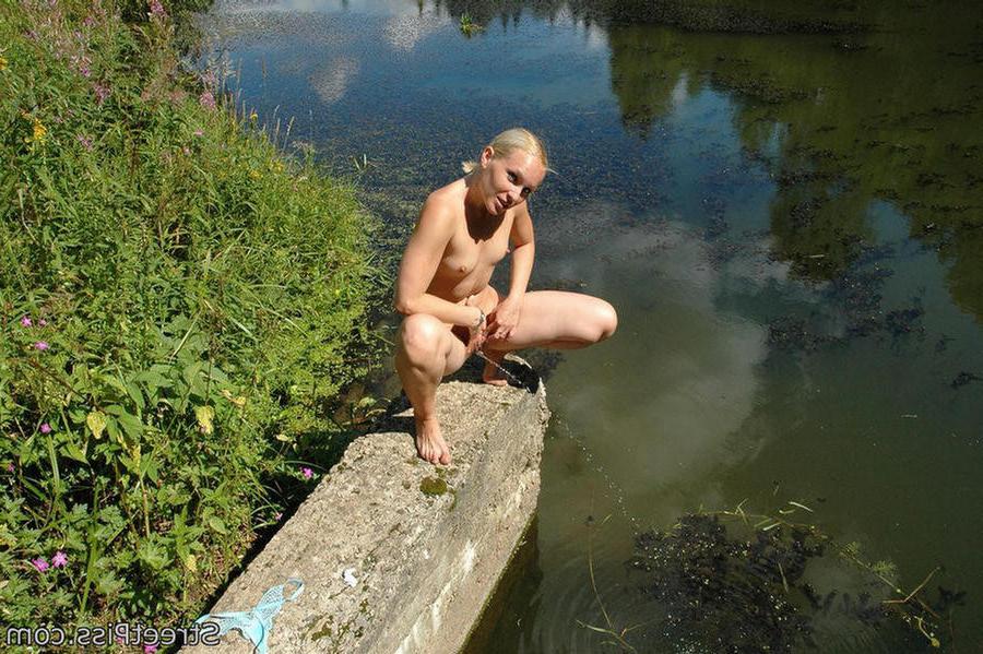12P Sexy blonde urinates near a deserted summer river