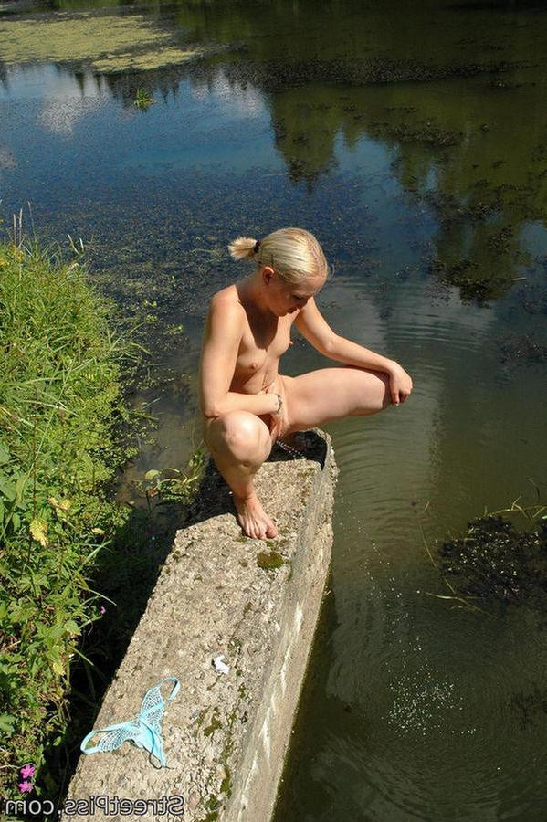 12P Sexy blonde urinates near a deserted summer river