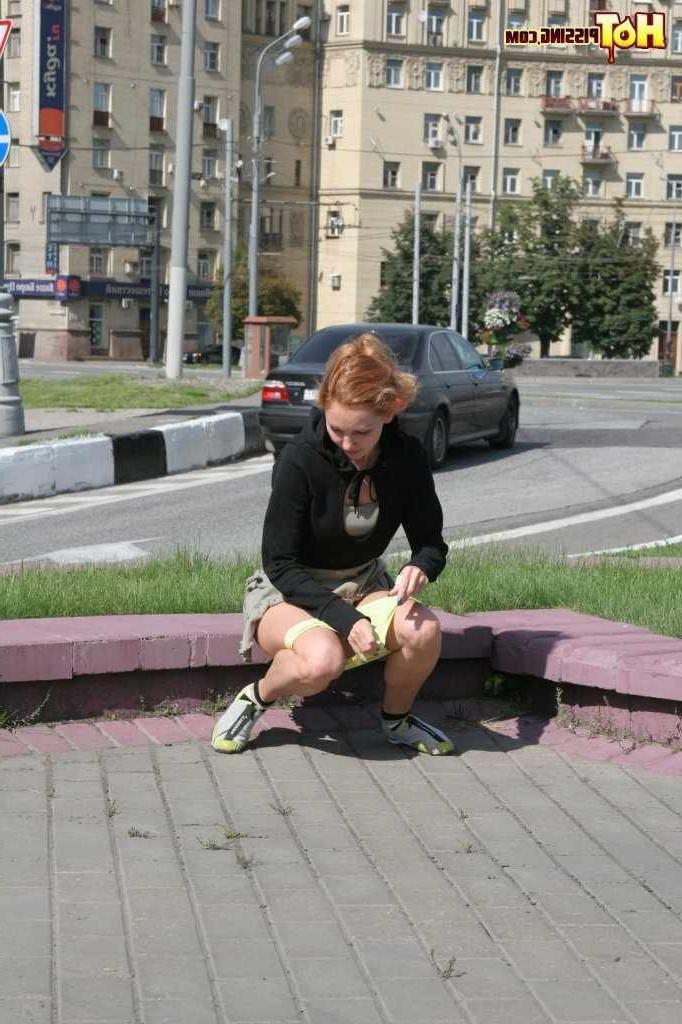 16P Girl pissing next to a street