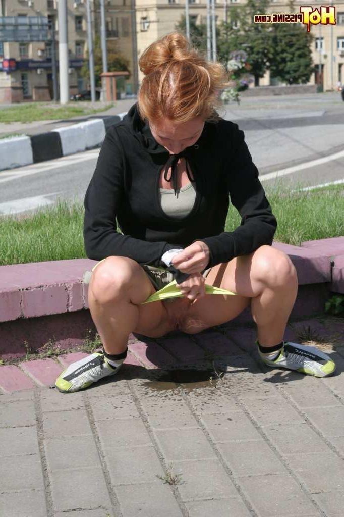 16P Girl pissing next to a street