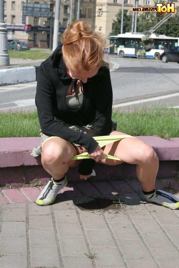 16P Girl pissing next to a street