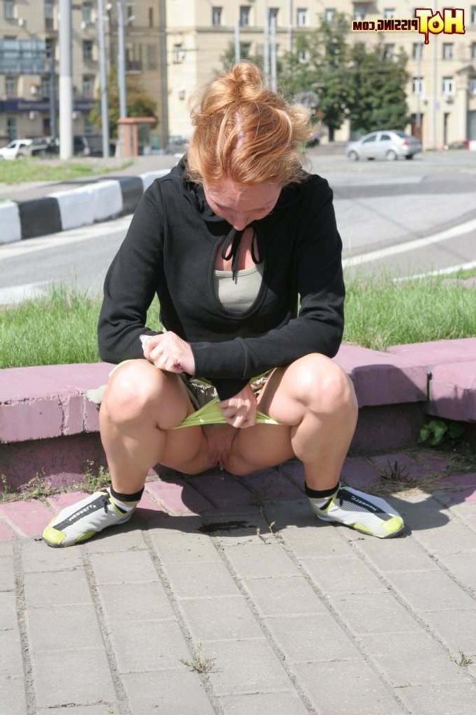 16P Girl pissing next to a street