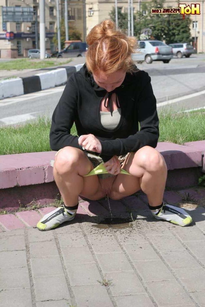 16P Girl pissing next to a street
