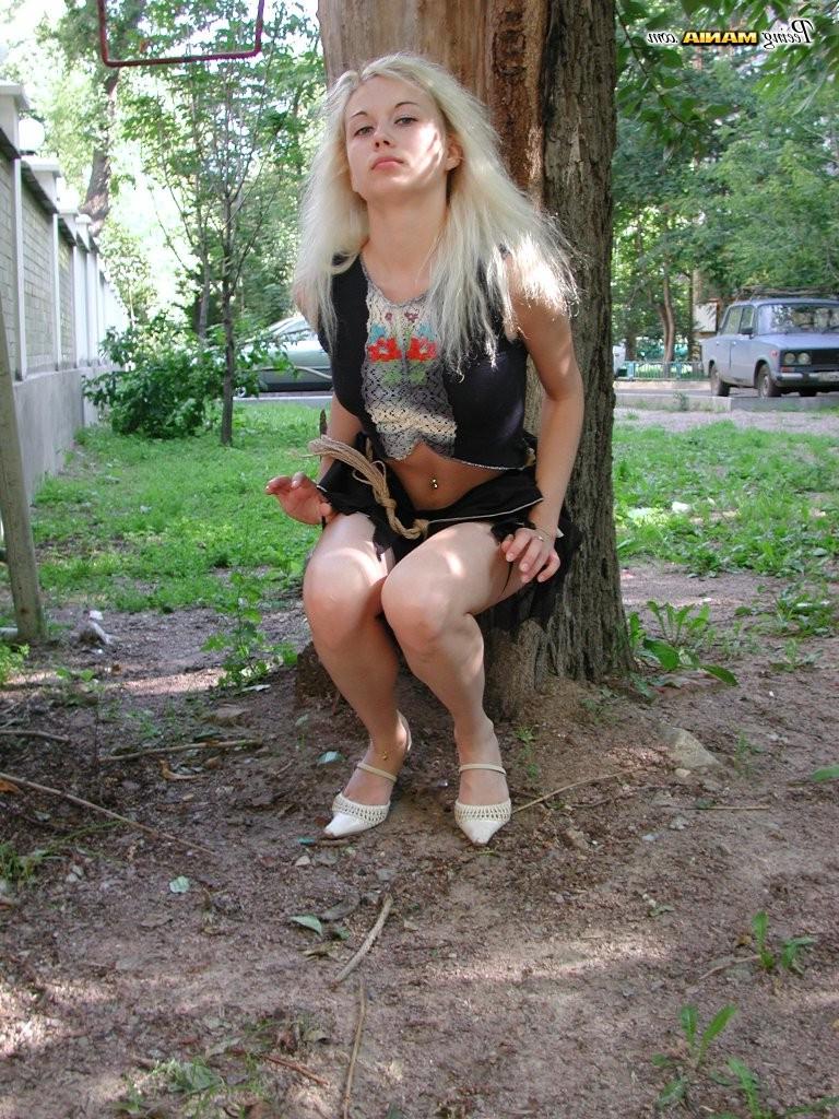 15P Pee-needed blonde squats behind a tree to relieve herself in the park