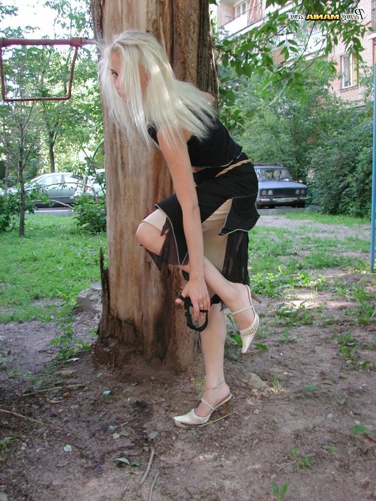 15P Pee-needed blonde squats behind a tree to relieve herself in the park