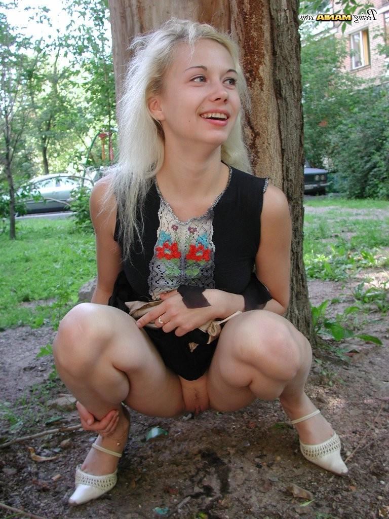 15P Pee-needed blonde squats behind a tree to relieve herself in the park
