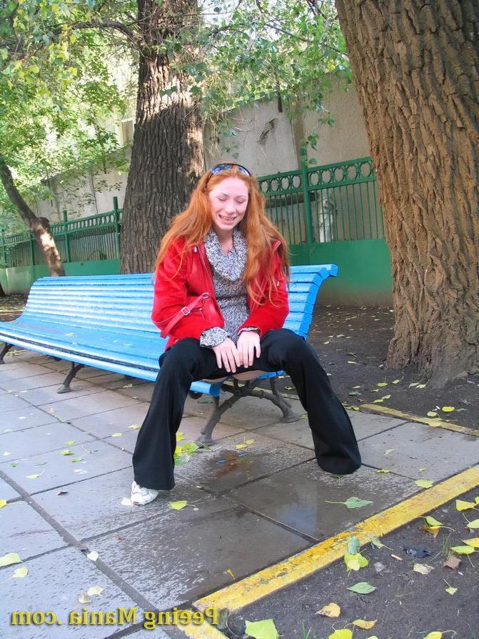 15P Naughty redhead gal pulls her jeans down and makes a pee on the bench