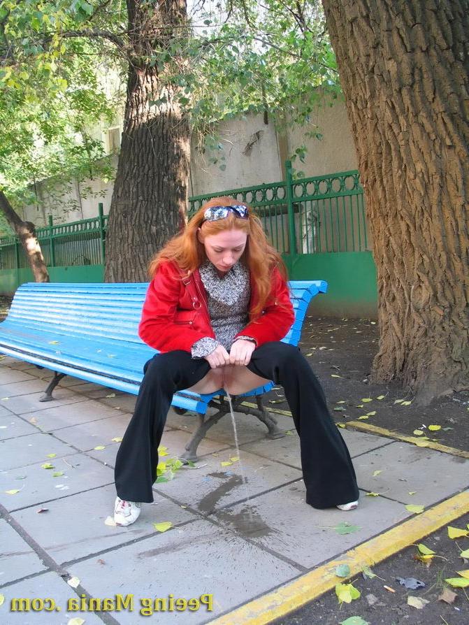 15P Naughty redhead gal pulls her jeans down and makes a pee on the bench