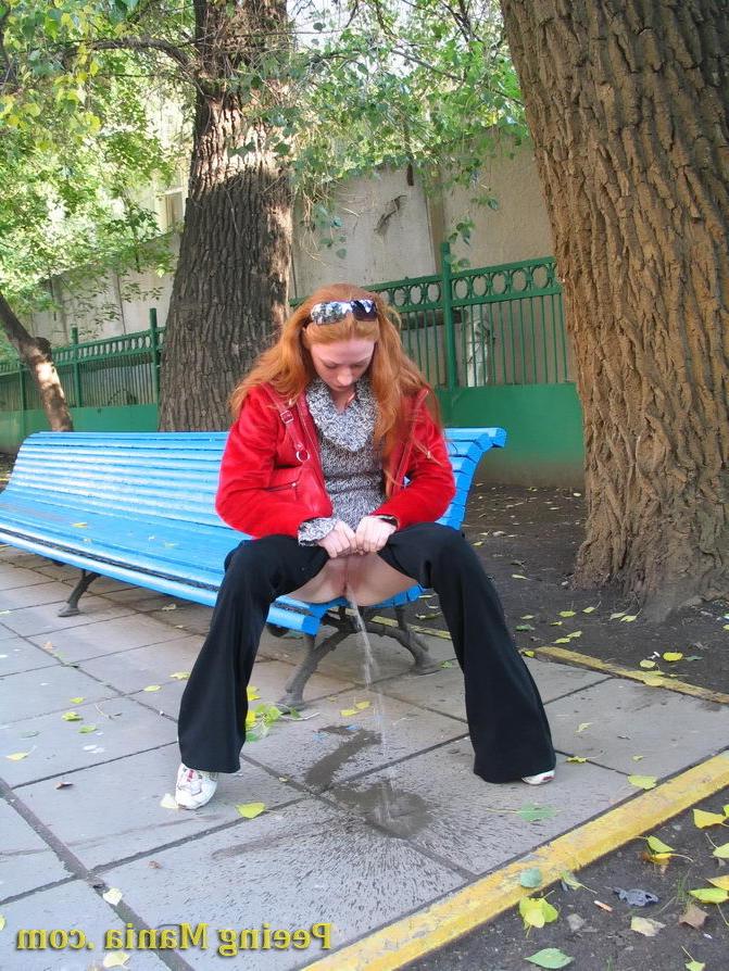 15P Naughty redhead gal pulls her jeans down and makes a pee on the bench