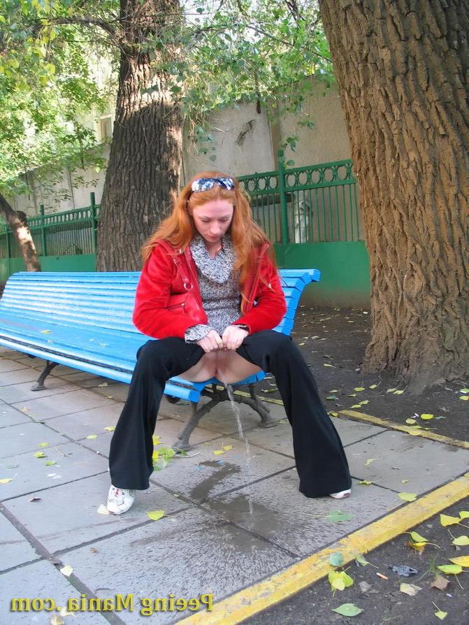 15P Naughty redhead gal pulls her jeans down and makes a pee on the bench