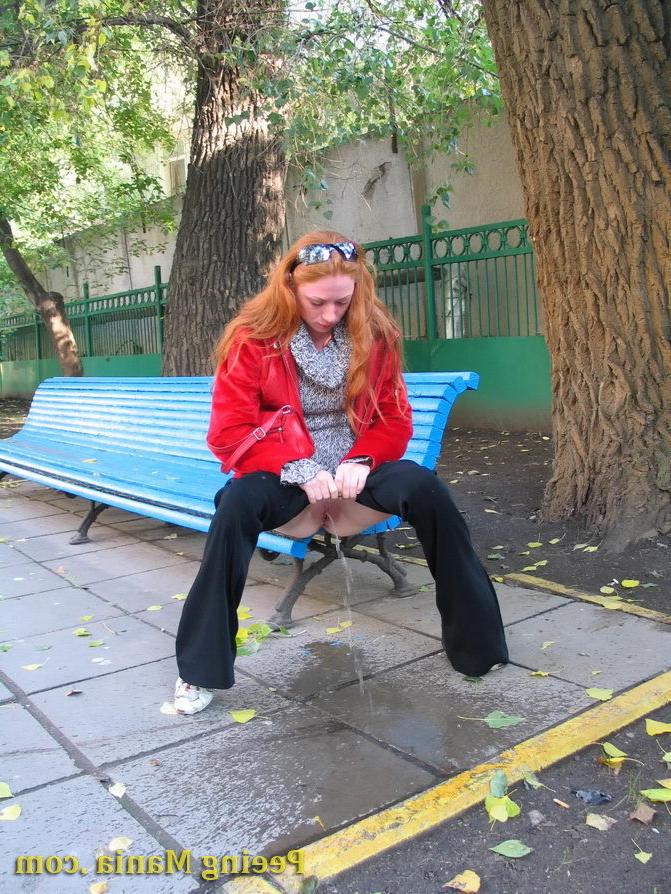 15P Naughty redhead gal pulls her jeans down and makes a pee on the bench