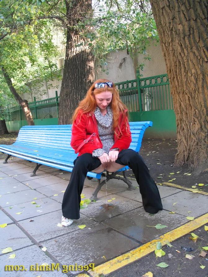 15P Naughty redhead gal pulls her jeans down and makes a pee on the bench