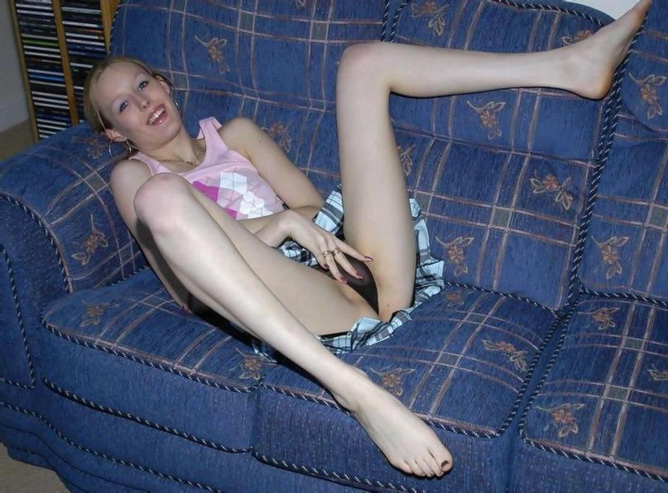 16P Skinny chick plays with her dildo on the couch