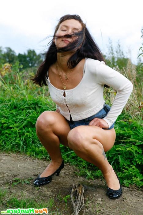 16P Babe tinkles on a road in the middle of a field