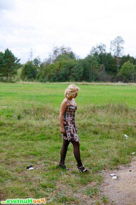 16P Blonde girl takes a leak in the middle of a field