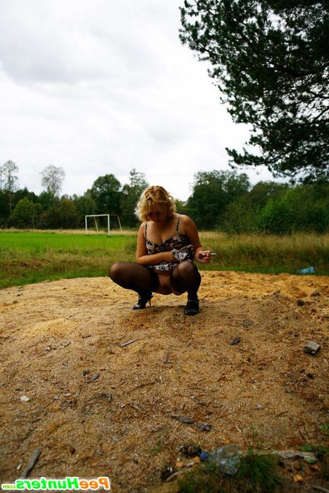 16P Blonde girl takes a leak in the middle of a field