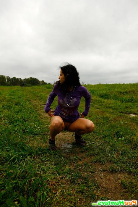 16P Girl pulls the hem of her dress up to pee outdoors