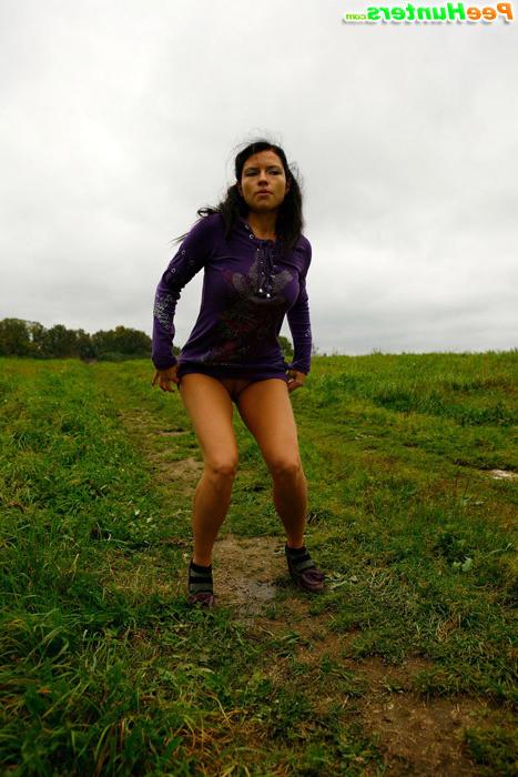 16P Girl pulls the hem of her dress up to pee outdoors