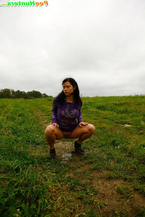 16P Girl pulls the hem of her dress up to pee outdoors