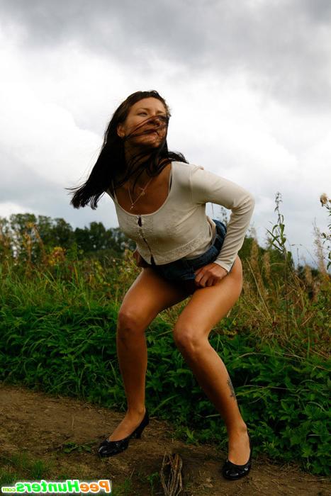 16P Cute brunette babe pisses up a storm in the field