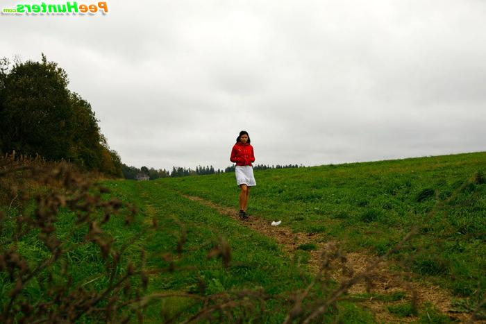 16P Barely legal brunette tinkling alone on a field