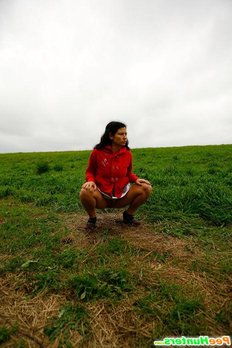 16P Barely legal brunette tinkling alone on a field