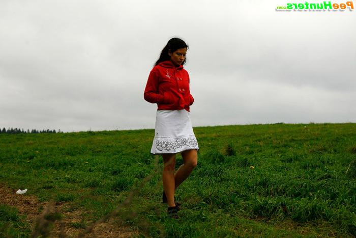 16P Barely legal brunette tinkling alone on a field