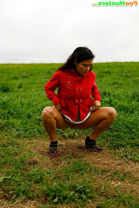 16P Barely legal brunette tinkling alone on a field