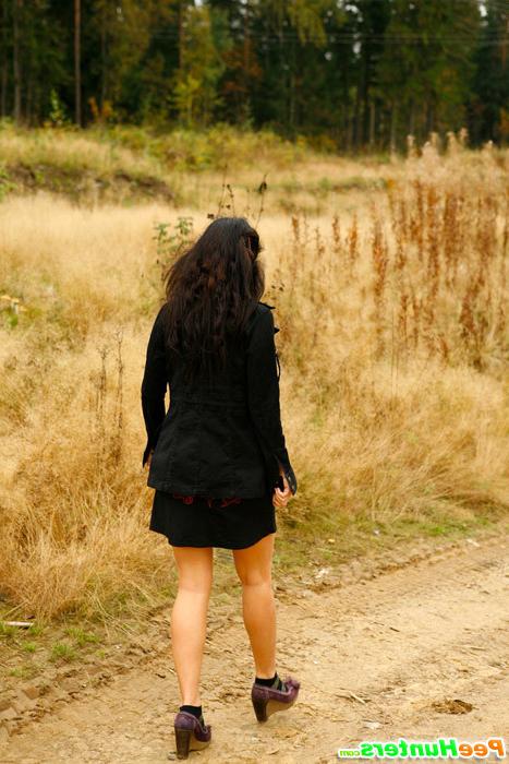 16P Beautiful brunette filmed pissing behind the bush