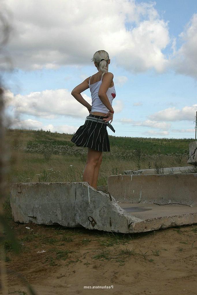 15P Yummy blonde teenie sits down and takes a piss outdoors