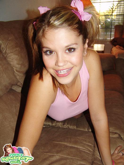 16P Sweet Teen Topanga teases in a pink top while laying on the couc