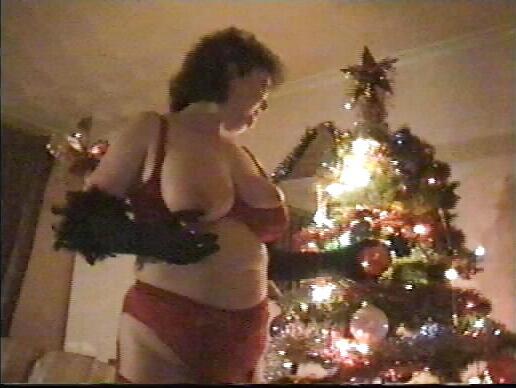 25P Buxom mature redhead by the Xmas tree