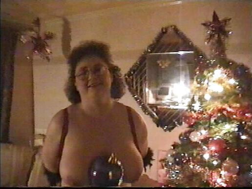25P Buxom mature redhead by the Xmas tree