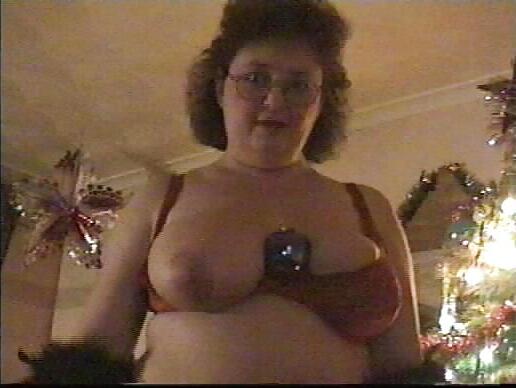 25P Buxom mature redhead by the Xmas tree