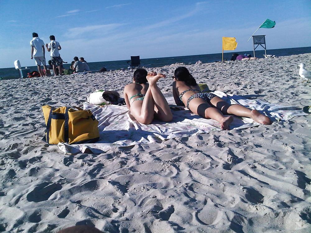18P Asians laying on the beach