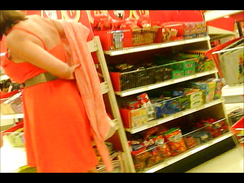 6P Latino putting on sweater over dress