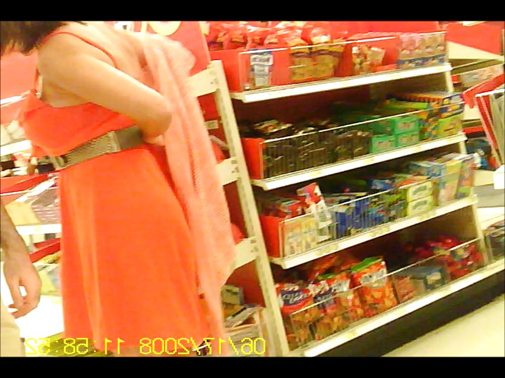 6P Latino putting on sweater over dress