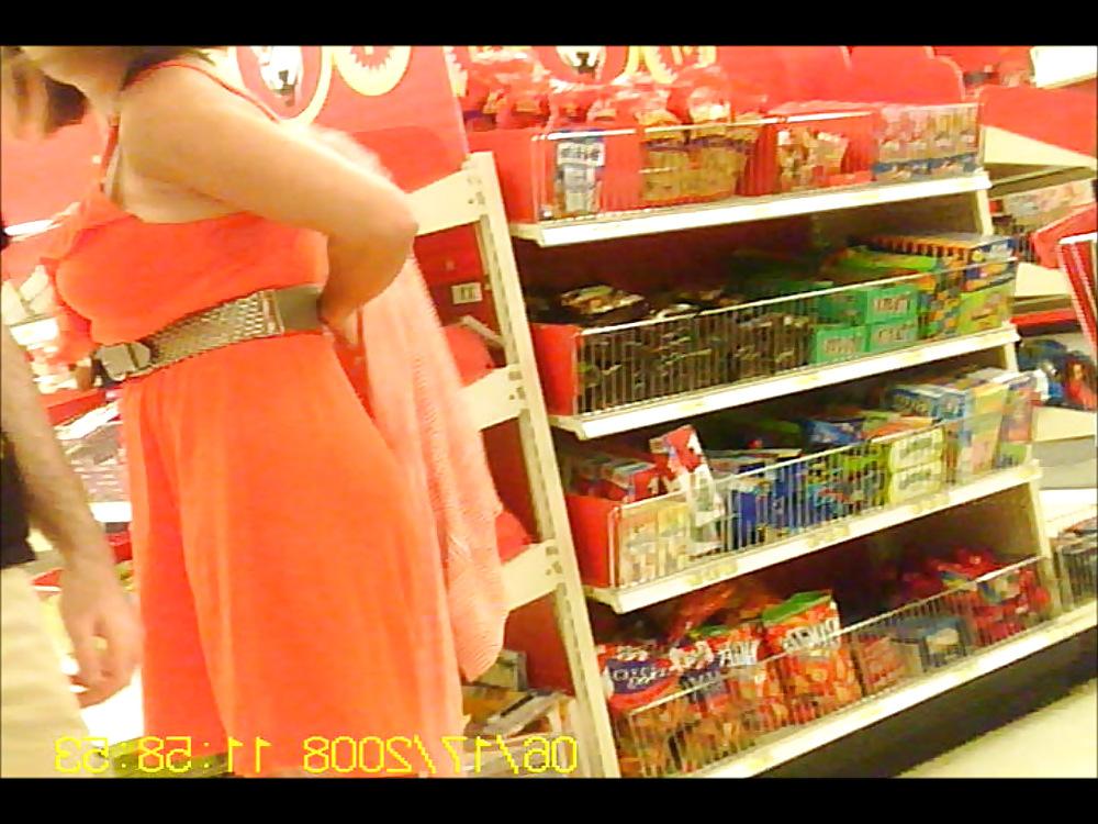 6P Latino putting on sweater over dress