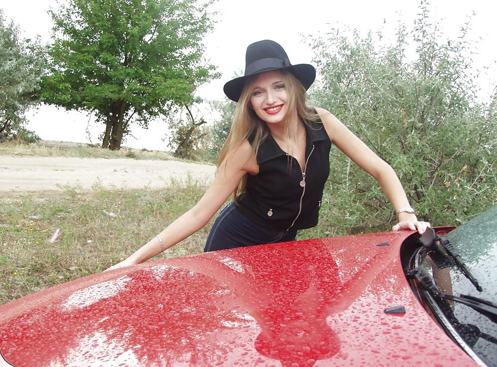 25P Blonde posing by her car