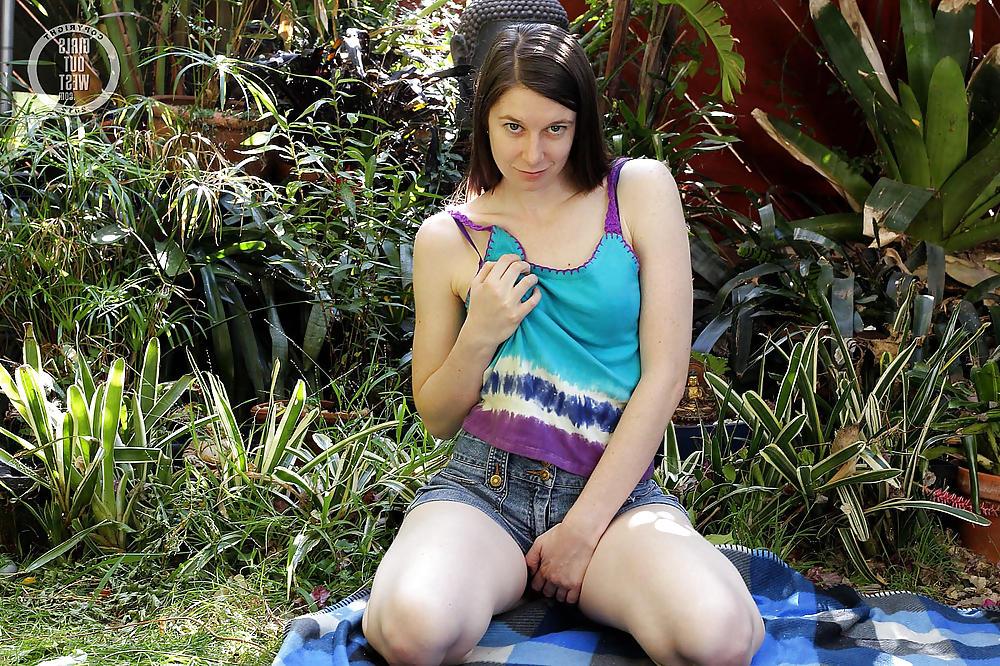16P A pale Australian girl playing with a toy outdoors