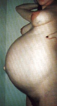 17P Pregnant brunette posing her lovely belly